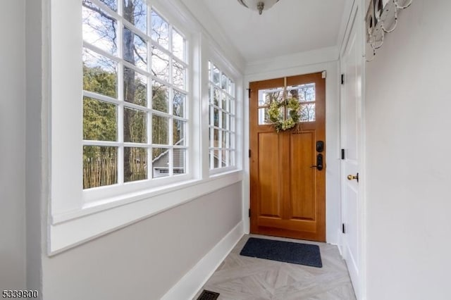 doorway to outside with baseboards