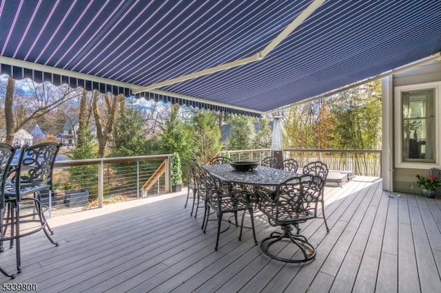 wooden terrace featuring outdoor dining area