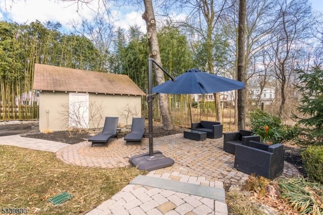 view of patio featuring a storage unit, an outdoor structure, fence, and an outdoor living space