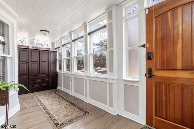 sunroom featuring a wealth of natural light and wood ceiling