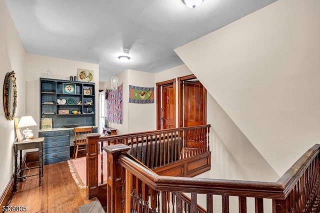 staircase with wood finished floors