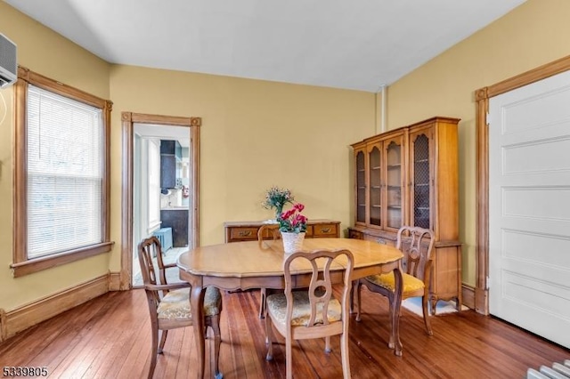 dining room featuring hardwood / wood-style flooring and baseboards