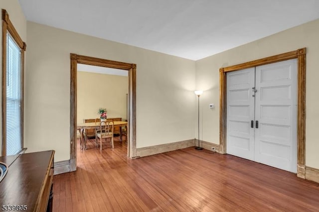 entryway featuring hardwood / wood-style flooring and baseboards