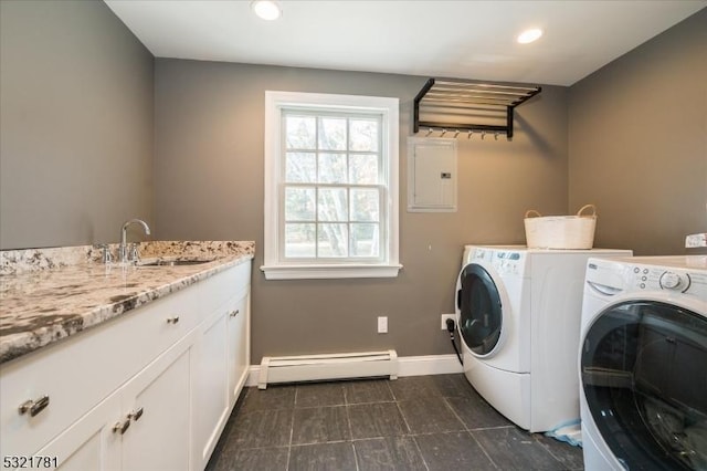 laundry area featuring electric panel, washer and clothes dryer, a baseboard heating unit, a sink, and recessed lighting