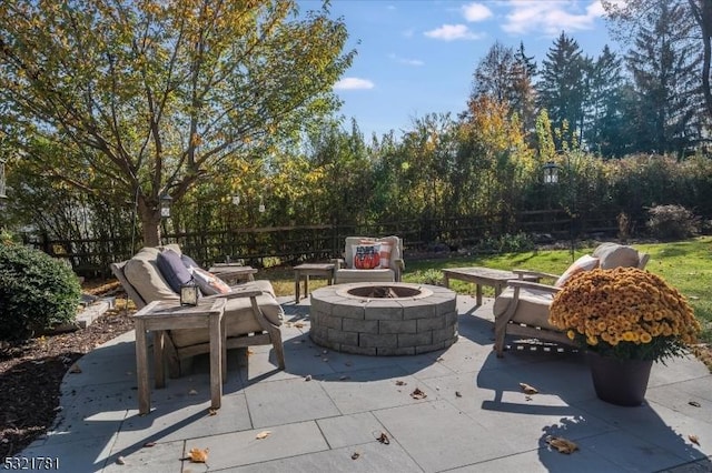 view of patio / terrace featuring a fire pit and fence