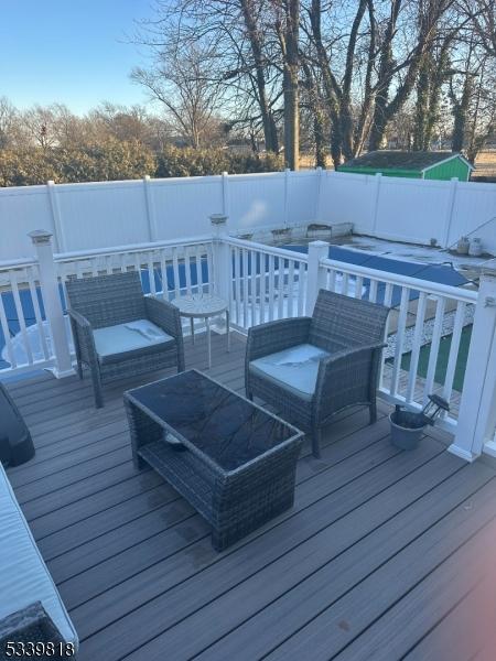 wooden deck with a fenced backyard