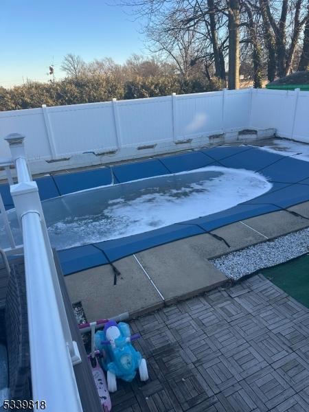 view of pool featuring a patio area and fence