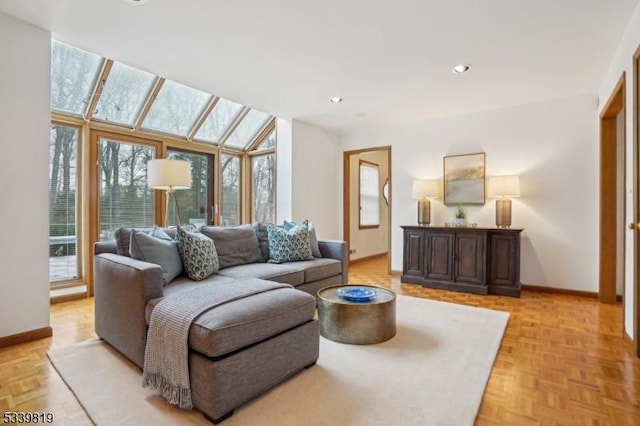 living room featuring recessed lighting, baseboards, and a skylight