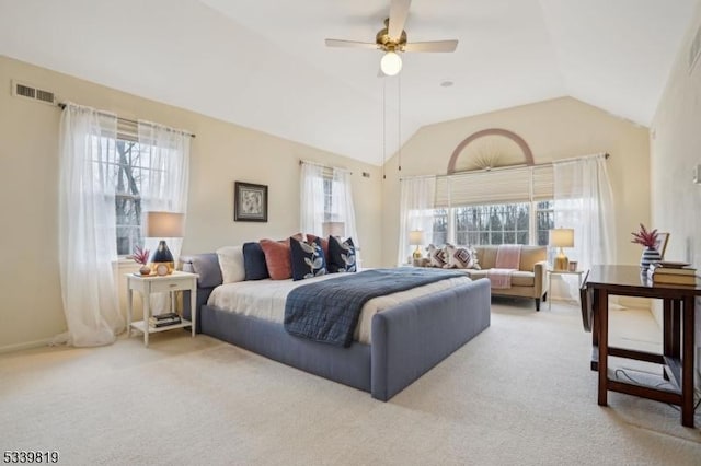 bedroom featuring light carpet, visible vents, vaulted ceiling, and a ceiling fan