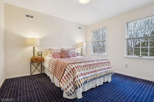 bedroom with visible vents, dark carpet, and baseboards