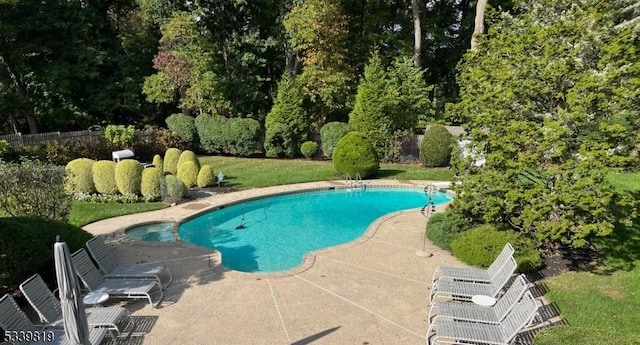 view of pool with a patio, a lawn, and a fenced in pool