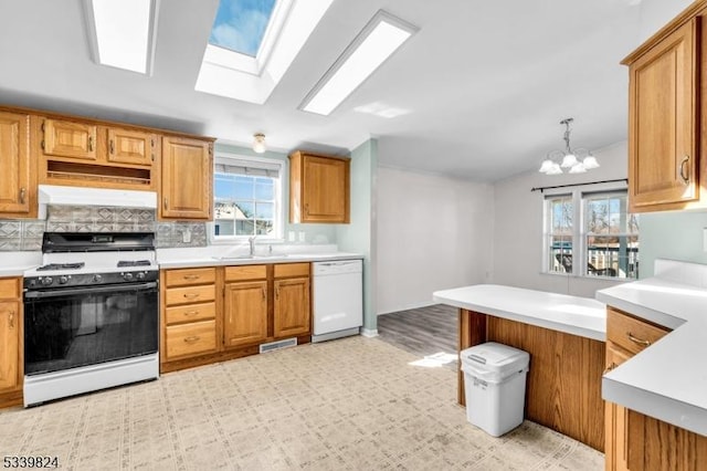 kitchen with light countertops, white appliances, and plenty of natural light