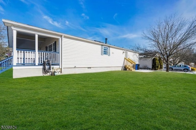 view of side of property with a porch, entry steps, crawl space, and a lawn