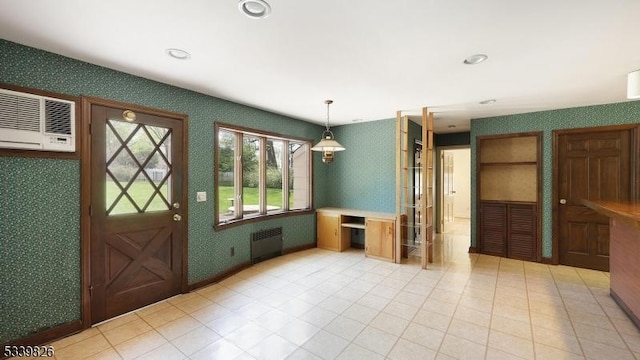 interior space with a wall unit AC, pendant lighting, wallpapered walls, radiator heating unit, and recessed lighting