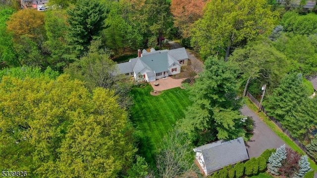 drone / aerial view featuring a forest view
