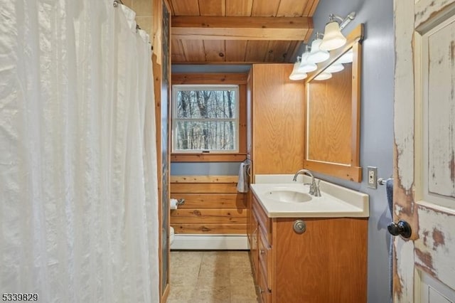 bathroom featuring wooden ceiling, a baseboard radiator, curtained shower, vanity, and beam ceiling