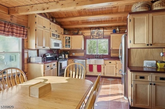 kitchen featuring light tile patterned floors, wood ceiling, appliances with stainless steel finishes, and a wealth of natural light