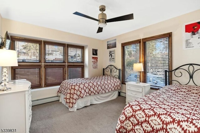 bedroom with carpet, multiple windows, and baseboard heating