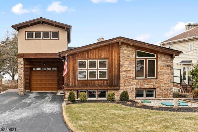 view of front of home featuring an attached garage, stone siding, a front lawn, and aphalt driveway