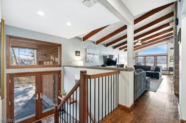 corridor featuring french doors, visible vents, lofted ceiling with beams, an upstairs landing, and hardwood / wood-style flooring