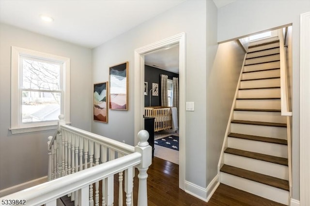 stairs with baseboards and wood finished floors