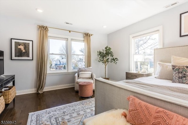 bedroom featuring visible vents, multiple windows, dark wood-type flooring, and baseboards