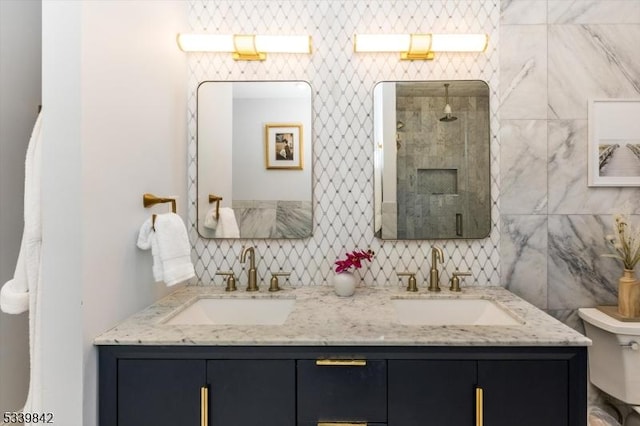 bathroom with double vanity, tiled shower, tasteful backsplash, and a sink