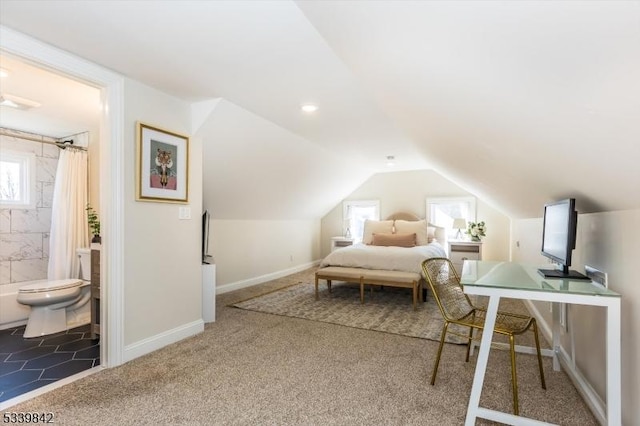 bedroom featuring lofted ceiling, baseboards, carpet floors, and connected bathroom