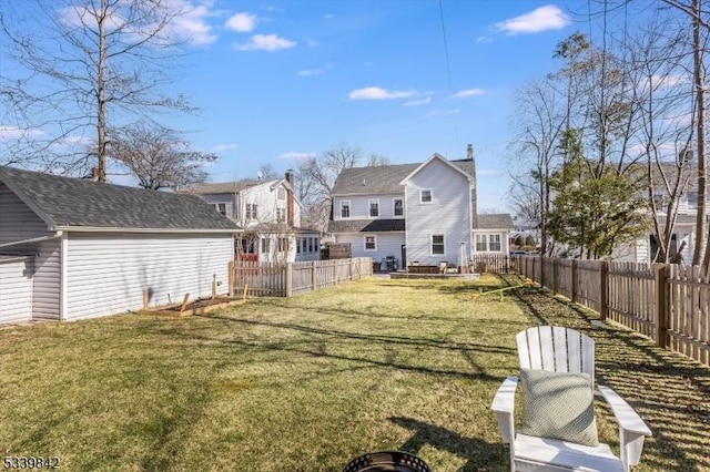 view of yard featuring an outdoor structure and a fenced backyard