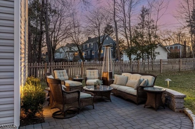 view of patio with an outdoor living space, fence, and a residential view