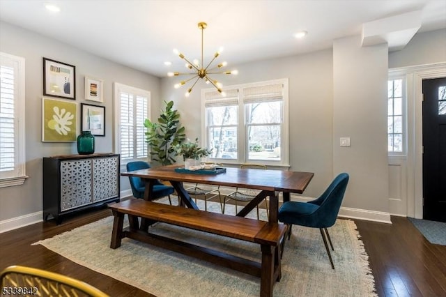 dining area with dark wood-style floors, a notable chandelier, recessed lighting, and baseboards