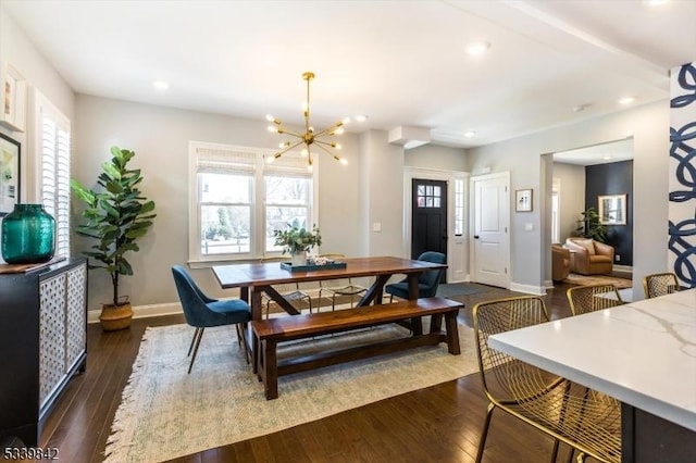 dining space with dark wood-type flooring, a notable chandelier, recessed lighting, and plenty of natural light