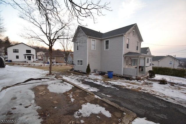 snow covered property featuring a residential view