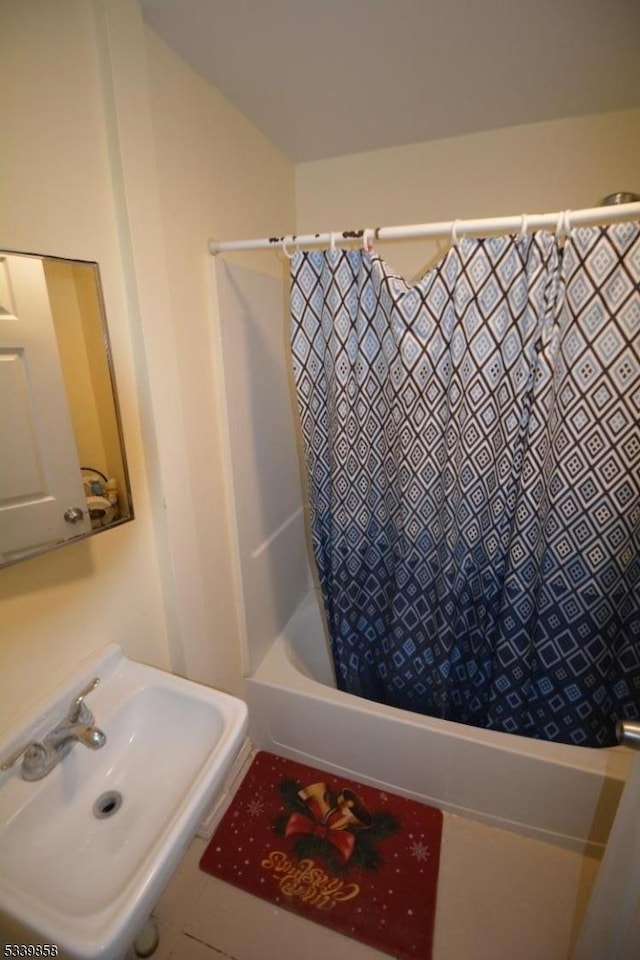 full bathroom with shower / bath combo and a sink