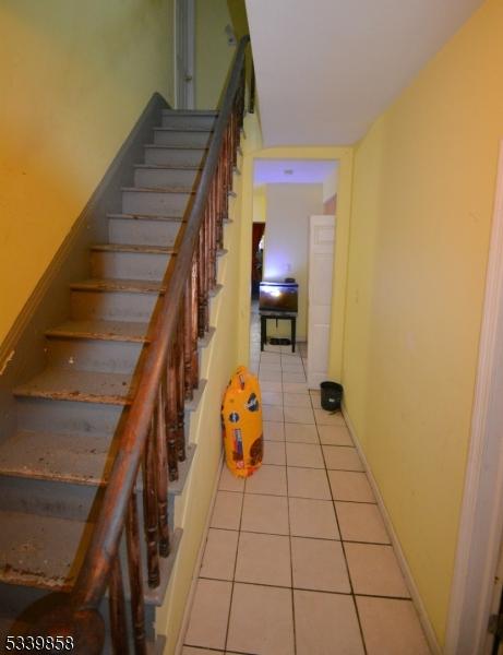 stairway with tile patterned flooring