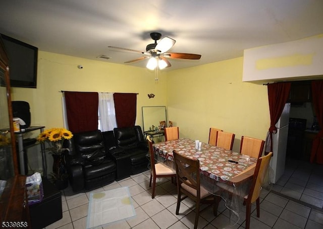 dining space featuring light tile patterned flooring, ceiling fan, and visible vents