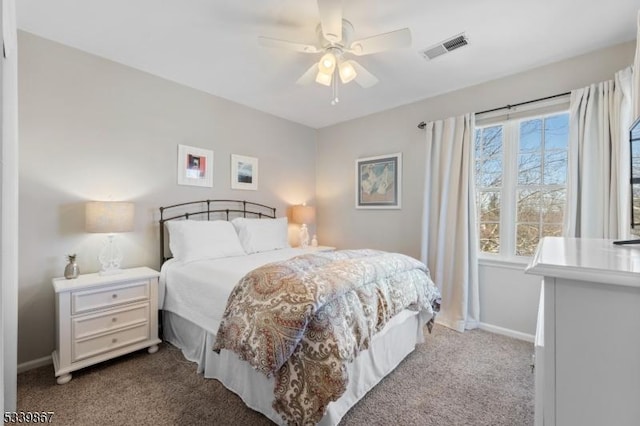 bedroom featuring light carpet, baseboards, visible vents, and ceiling fan