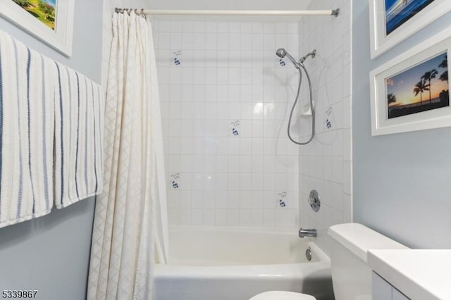 bathroom featuring toilet, shower / tub combo, and vanity