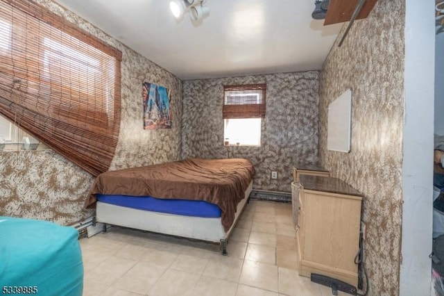 bedroom with light tile patterned floors