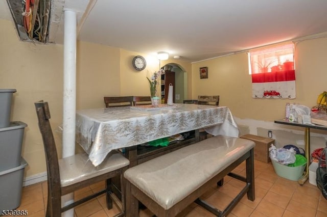 dining room with tile patterned flooring and arched walkways