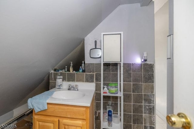 bathroom featuring vaulted ceiling and vanity