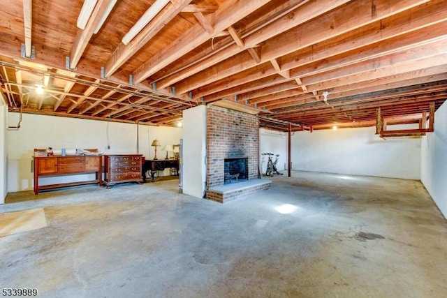 basement featuring a brick fireplace