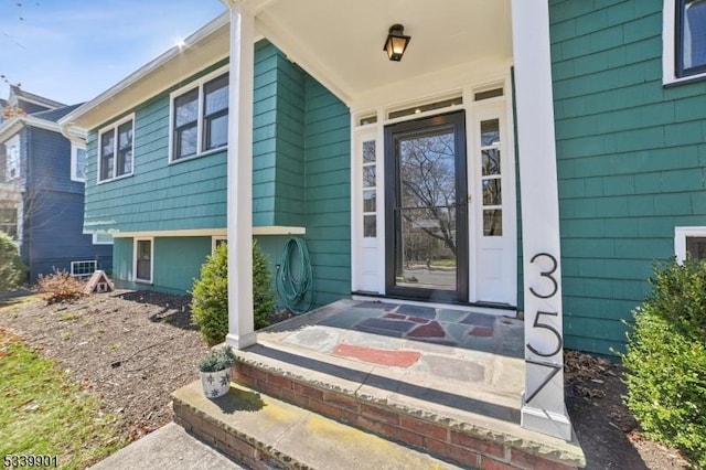 view of exterior entry featuring a porch