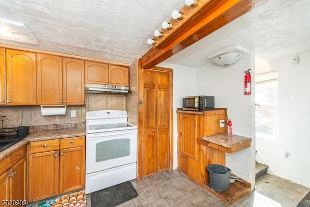 kitchen featuring under cabinet range hood, electric range, black microwave, and brown cabinets