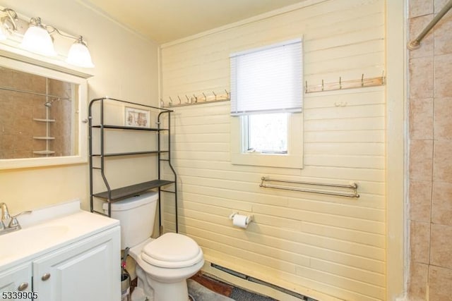 full bath with toilet, a tile shower, and vanity