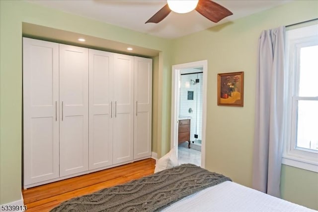 bedroom featuring a ceiling fan, a closet, and light wood finished floors