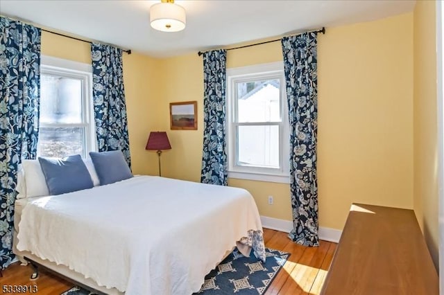 bedroom featuring baseboards and wood finished floors