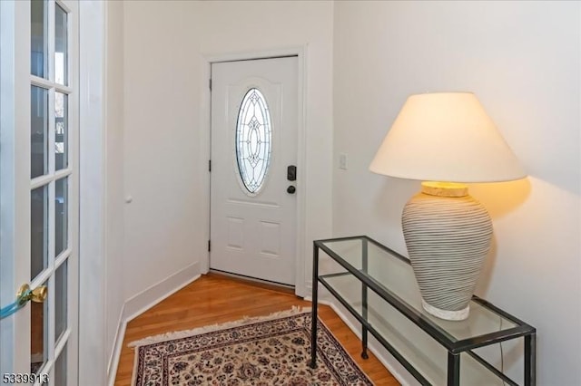 entryway with wood finished floors