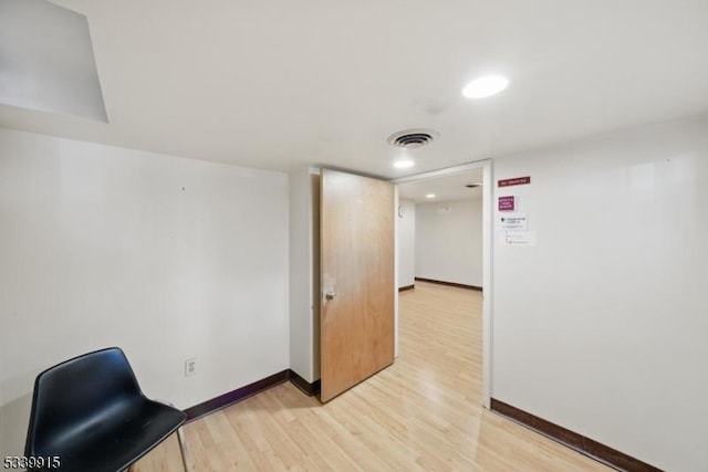 office space with baseboards, visible vents, and light wood-style flooring