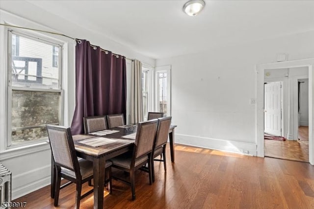 dining space with plenty of natural light and wood finished floors